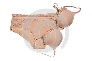 Women lingerie isolated. Close-up of beige or flesh-colored bra and panties isolated on a white background. Useful for wearing