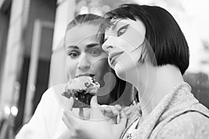 Women look at cupcake in paris, france