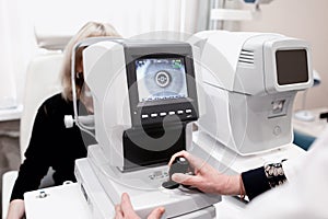 Women looking at eye test machine in ophthalmology clinic