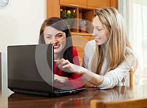 Women looking to laptop at table