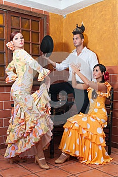 Women and man in traditional flamenco dresses dance during the Feria de Abril on April Spain photo