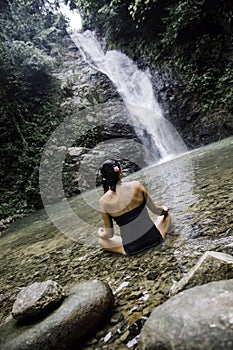 Women meditating outdoors in green park on nature background