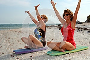 Women meditation on beach