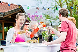 Women and men celebrating garden party