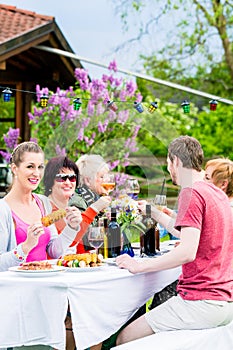 Women and men celebrating garden party