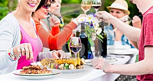 Women and men celebrating garden party