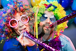 Women and men celebrating at party for new years eve or carnival