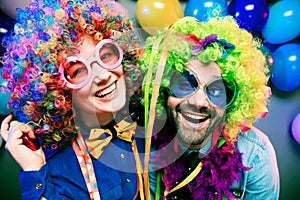 Women and men celebrating at party for new years eve or carnival