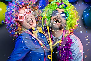 Women and men celebrating at party for new years eve or carnival