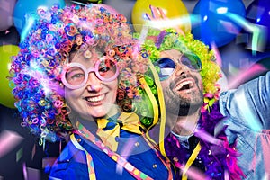 Women and men celebrating at party for new years eve or carnival