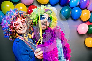 Women and men celebrating at party for new years eve or carnival