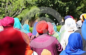women and men parade with viels and turbans