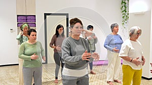 Women moving coordinated closing a qi gong class