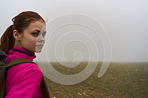 women in nature with a backpack in the mountains fog nature photo