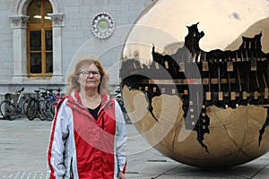 Women next to `sphere within sphere` in Dublin Ireland, Trinity University