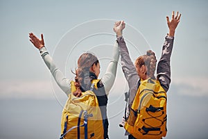 Women outdoor travel, celebrate success adventure and hiking support achievement on mountain top. Blue sky landscape