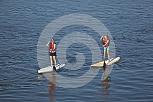 Women paddleboarding