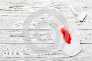 women pads and tampon - sanitary pads lies next to a tampon on an isolated background on a pink and violet