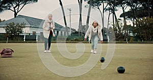 Women, park or old people bowling for fitness, training or exercise for wellness or teamwork outdoors. Senior ladies