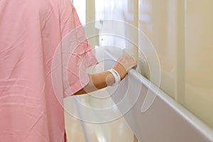 Women patient hand holding to handrail in hospital