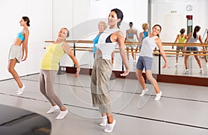 Women performing contemporary dance in training room