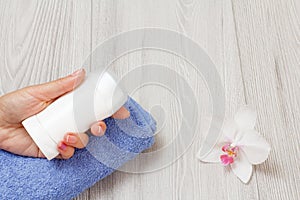 Women perfumers and cosmetics on a wooden background