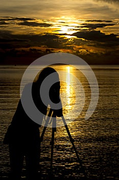 Women photographer Sunrise At the beach