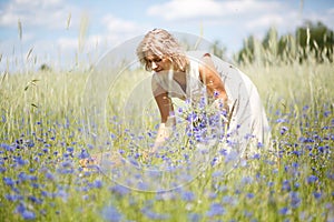 Women picking blue flowers