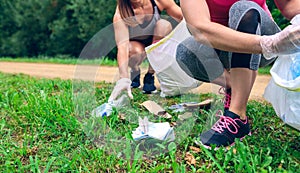 Women picking up trash doing plogging