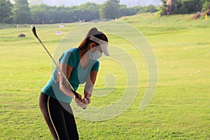 Women player golf swing shot on course