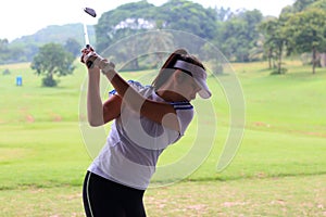 Women player golf swing shot on course