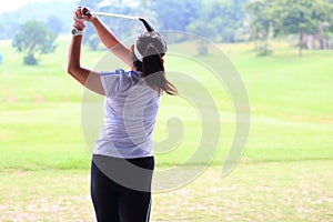 Women player golf swing shot on course