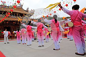 Women playing drum to celebrate the completion of taiqing palace