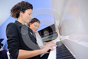 Women playing duet on piano