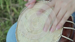 Women playing on Jambe Drum on nature