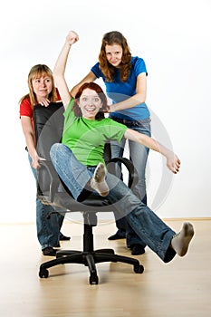 Women playing on office chair