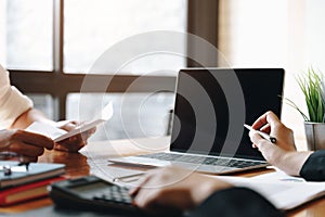 Women pointing into laptop computer monitor in meeting room.Young coworker woman team making business discussion in co-working