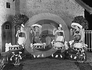 Women posing with huge baskets of eggs