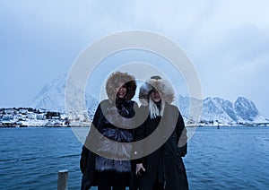 Women posing in the mountains of the Lofoten Islands. Reine, Norway