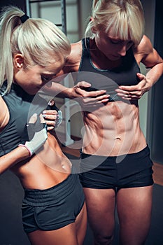 Women posing with perfect abdomen muscles