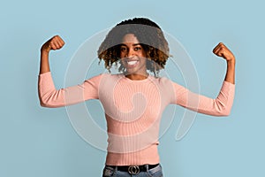Women Power. Strong Powerful African-American Woman Raising Hands And Showing Her Biceps