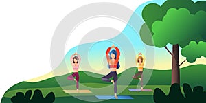 Women practice yoga outdoors in the park