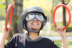 Women practicing gymnastics cheerfully, she wears hats and safety glasses