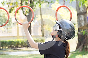 Women practicing gymnastics cheerfully, she wears hats and safety glasses