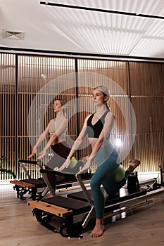 Women practicing Pilates with reformers in a