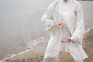 Women practicing Taijiquan on the beach