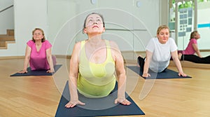 Women practicing yoga training - pose bhujangasana