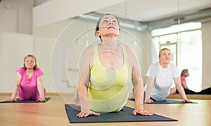 Women practicing yoga training - pose bhujangasana