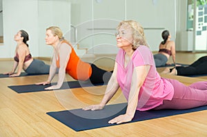 Women practicing yoga training - pose bhujangasana