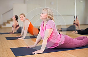 Women practicing yoga training - pose bhujangasana